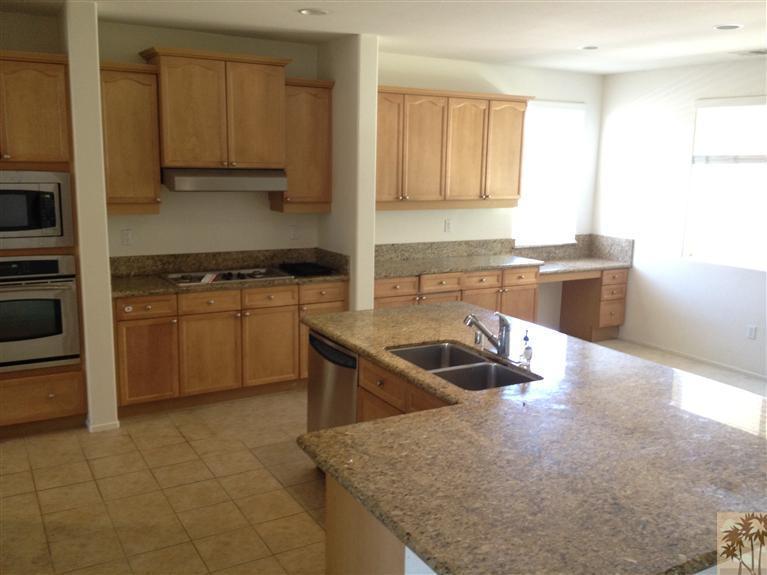 83449 Stagecoach Road Indio, CA 92203 - Photo 2 of 16 a kitchen with granite countertop a sink stove and cabinets