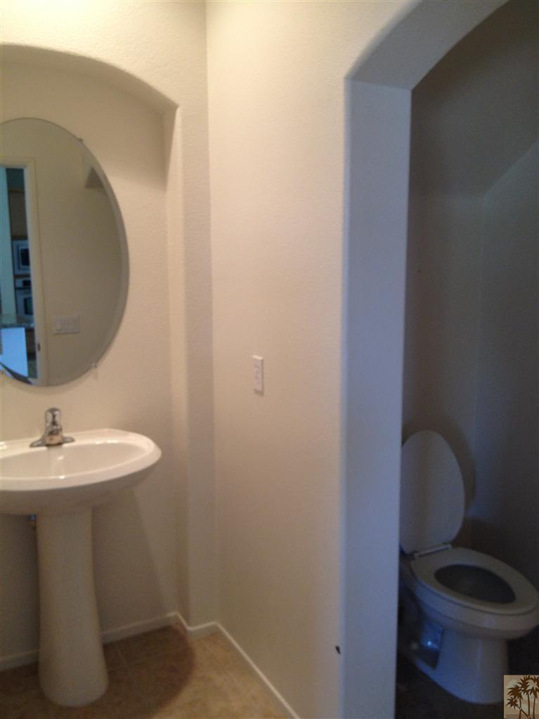 83449 Stagecoach Road Indio, CA 92203 - Photo 15 of 16 a bathroom with a toilet a sink and mirror