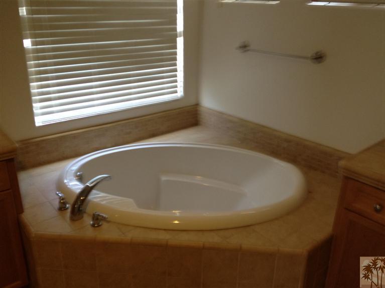 83449 Stagecoach Road Indio, CA 92203 - Photo 10 of 16 a bath tub sitting in a bathroom next to a window
