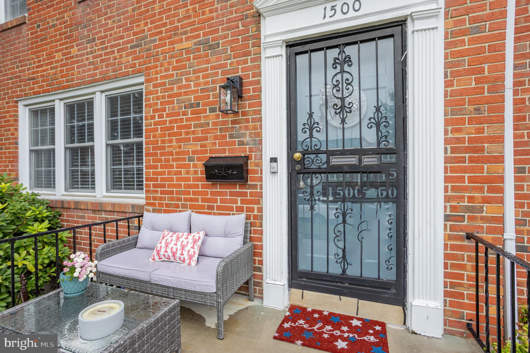1500 Doxbury Road Baltimore, MD 21286 - Photo 31 of 36 a brick building with a bench and potted plant