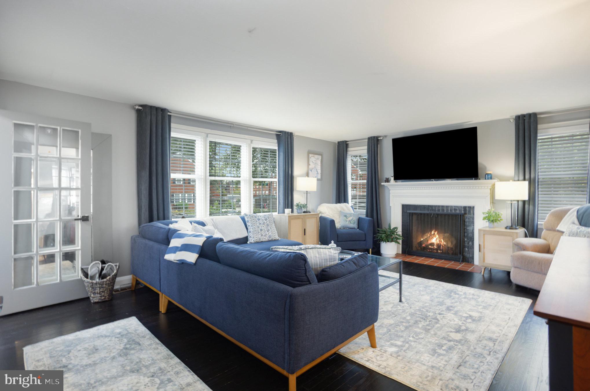 1500 Doxbury Road Baltimore, MD 21286 - Photo 4 of 36 a living room with furniture a flat screen tv and a fireplace