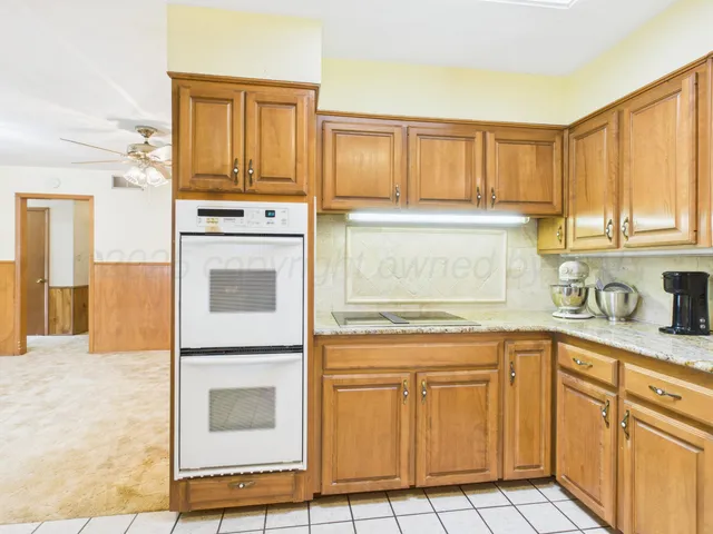a kitchen with a sink window and cabinets