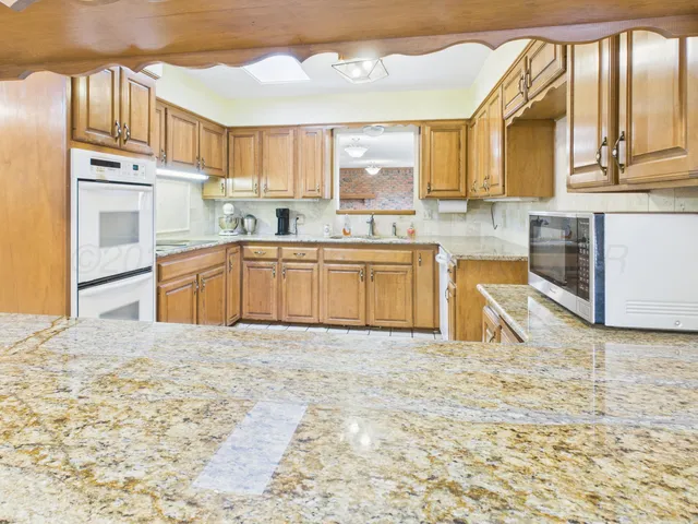 a view of a living room and kitchen view