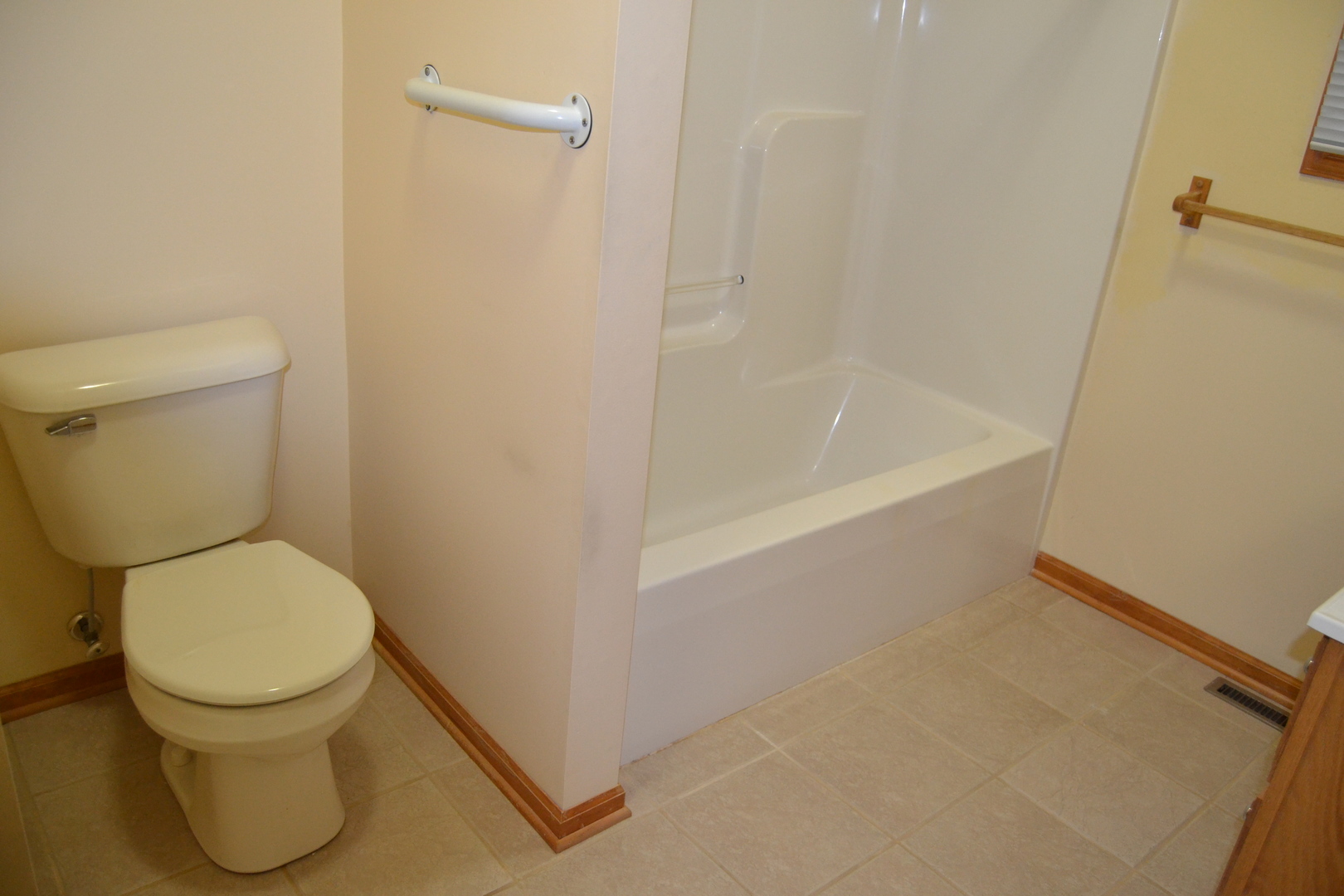 208 Nebraska Street, Unit A Ottawa, IL 61350 - Photo 5 of 14 a white toilet sitting next to a bath tub