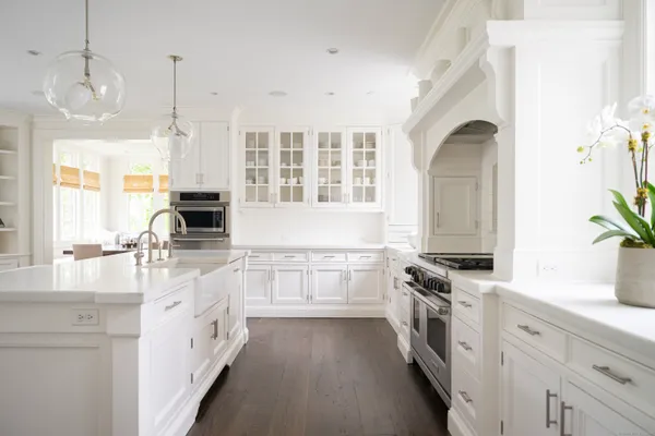 a kitchen with granite countertop a sink stove and cabinets
