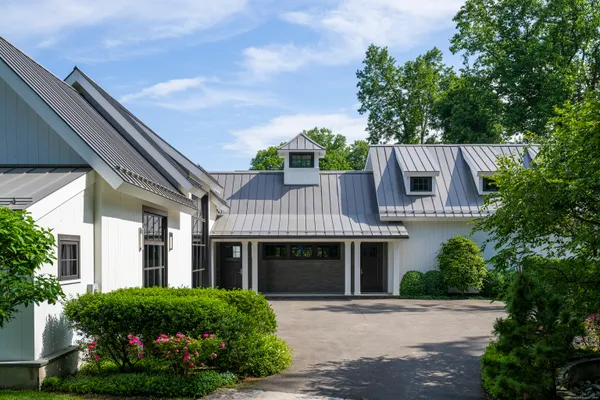 a front view of a house with a garden