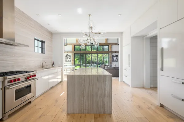 a kitchen with stove and white cabinets