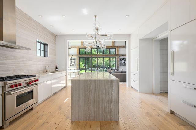 a kitchen with stove and white cabinets