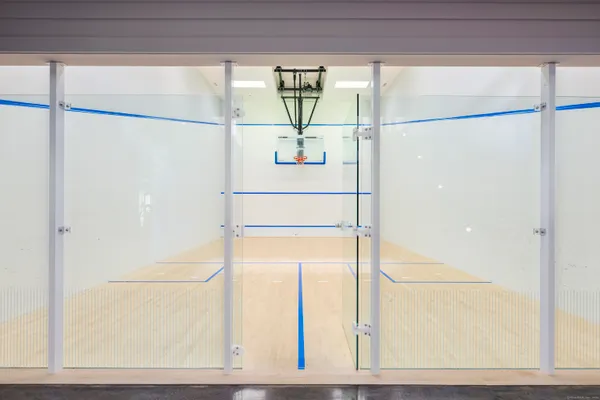 a living room with furniture large window and stainless steel appliances