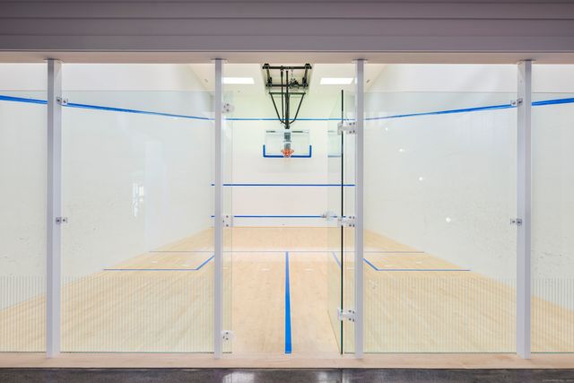 a living room with furniture large window and stainless steel appliances