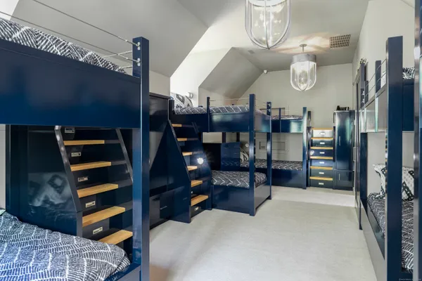 a front view of a house with a garden and trees