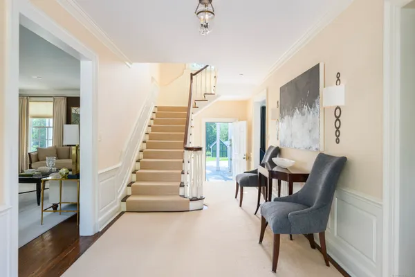 a view of a hallway with furniture and staircase