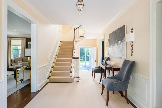 a view of a hallway with furniture and staircase