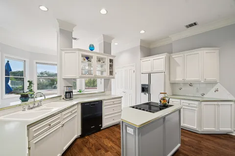 a kitchen with a sink stove and cabinets