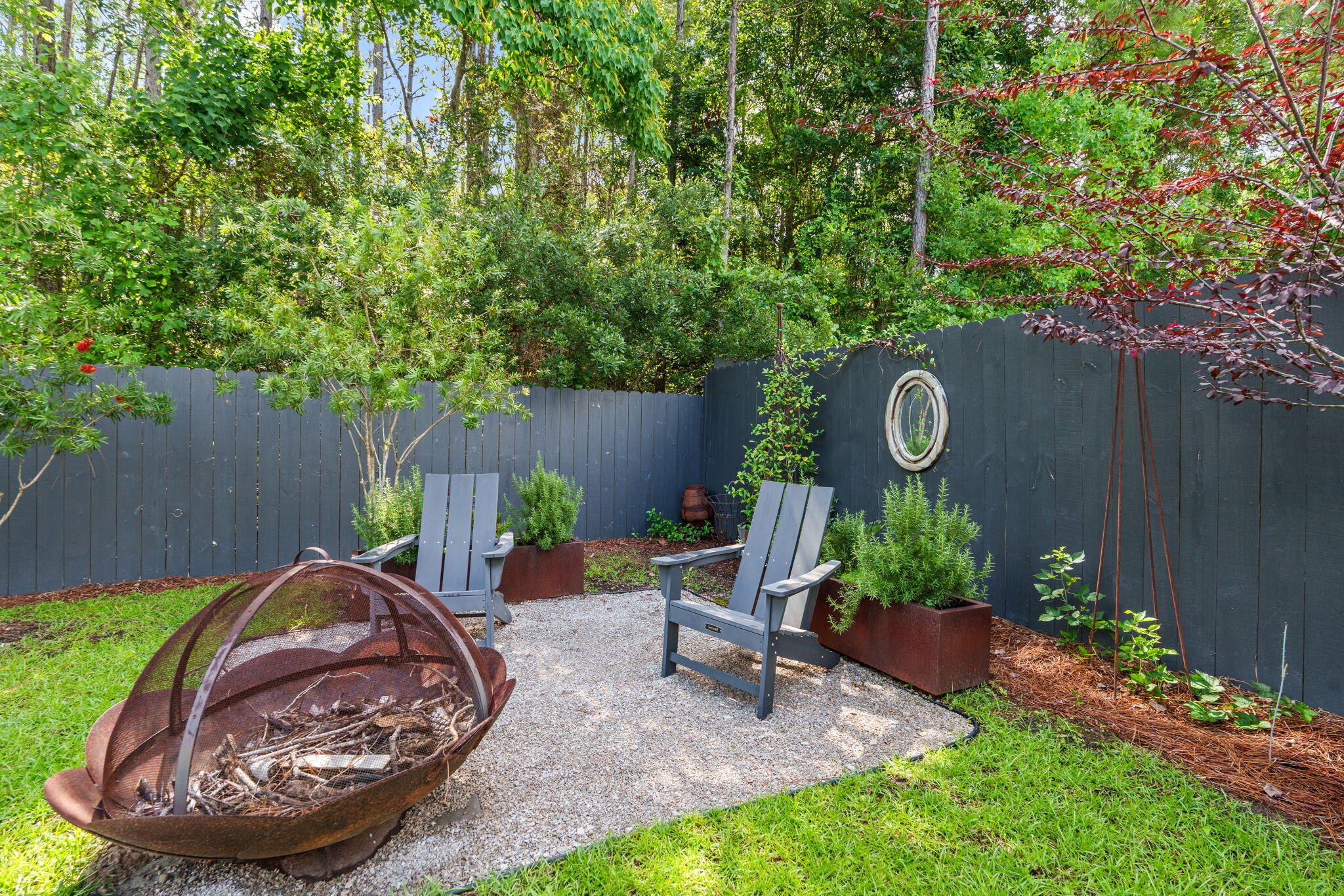 85 6th Street Santa Rosa Beach, FL 32459 - Photo 30 of 35 a view of a backyard with table and chairs potted plants and wooden fence