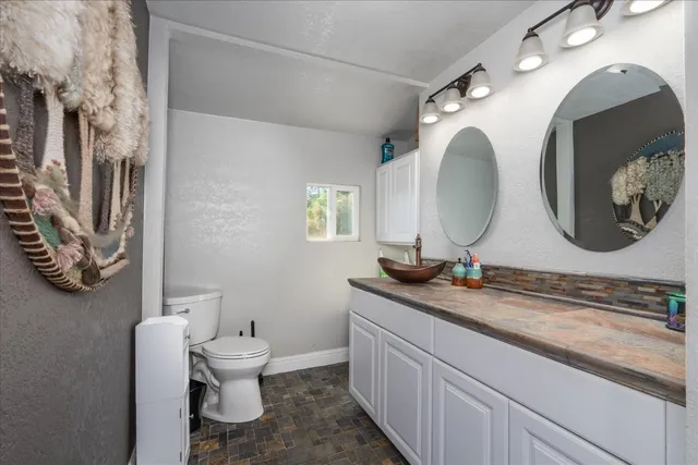 a bathroom with a double vanity sink and a mirror