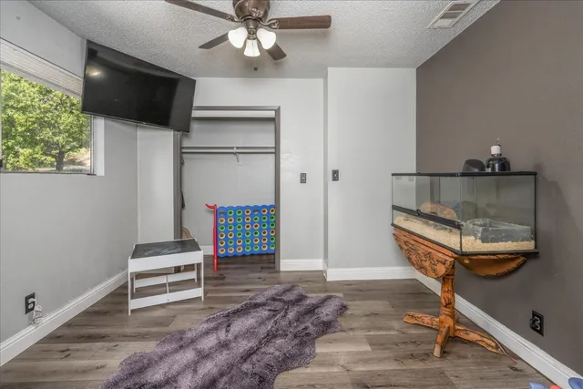 a living room with a flat screen tv and a rug