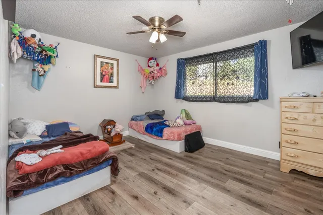 a bedroom with bed and wooden floor