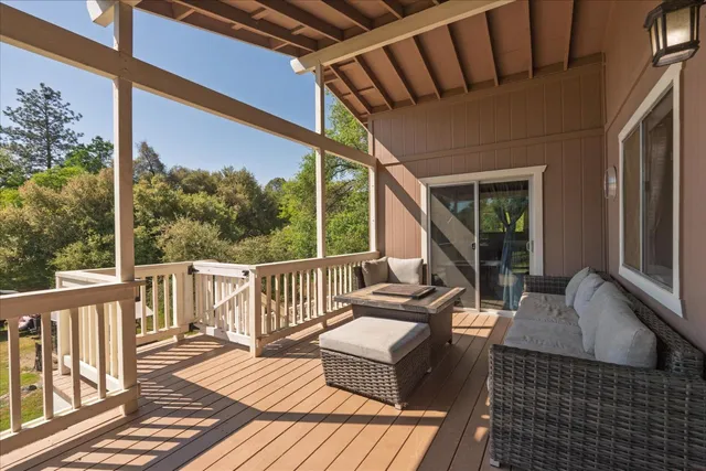 a balcony with wooden floor and furniture
