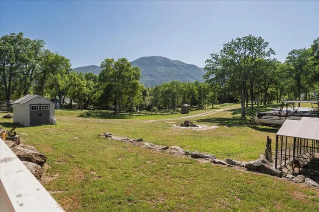 a view of swimming pool with a garden and trees
