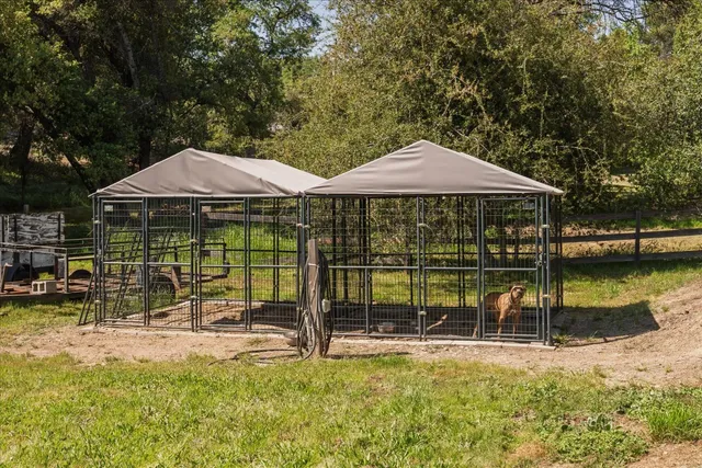a backyard of a house with yard table and chairs