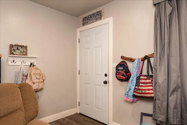 a view of front door with wooden floor