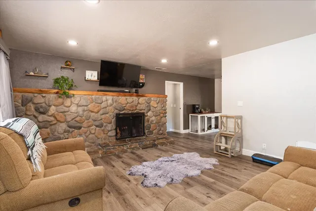 a living room with furniture a flat screen tv and a fireplace