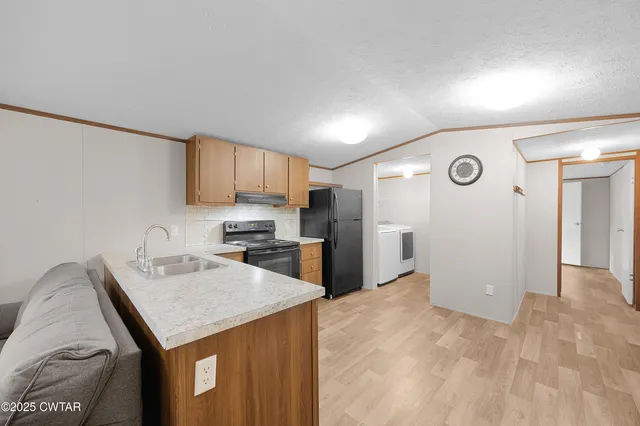 a kitchen with a refrigerator a sink and a cabinets