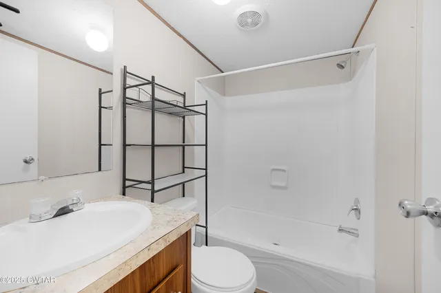 a bathroom with a sink toilet vanity and shower