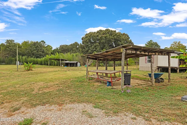 a view of a swimming pool with a table and chairs
