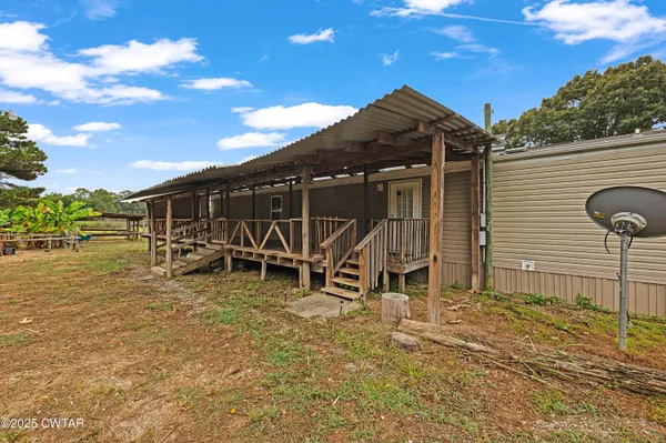 a view of a wooden chairs and table in the patio