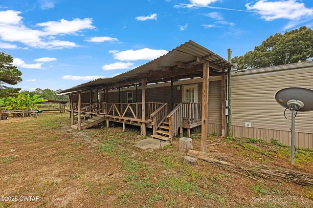 a view of a wooden chairs and table in the patio