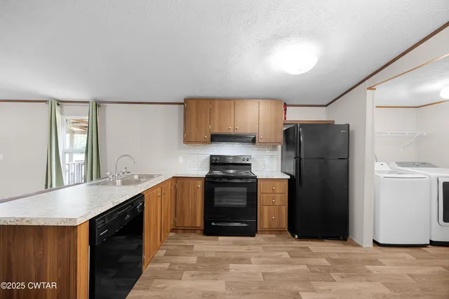 a kitchen with stainless steel appliances granite countertop a refrigerator a sink a stove and island