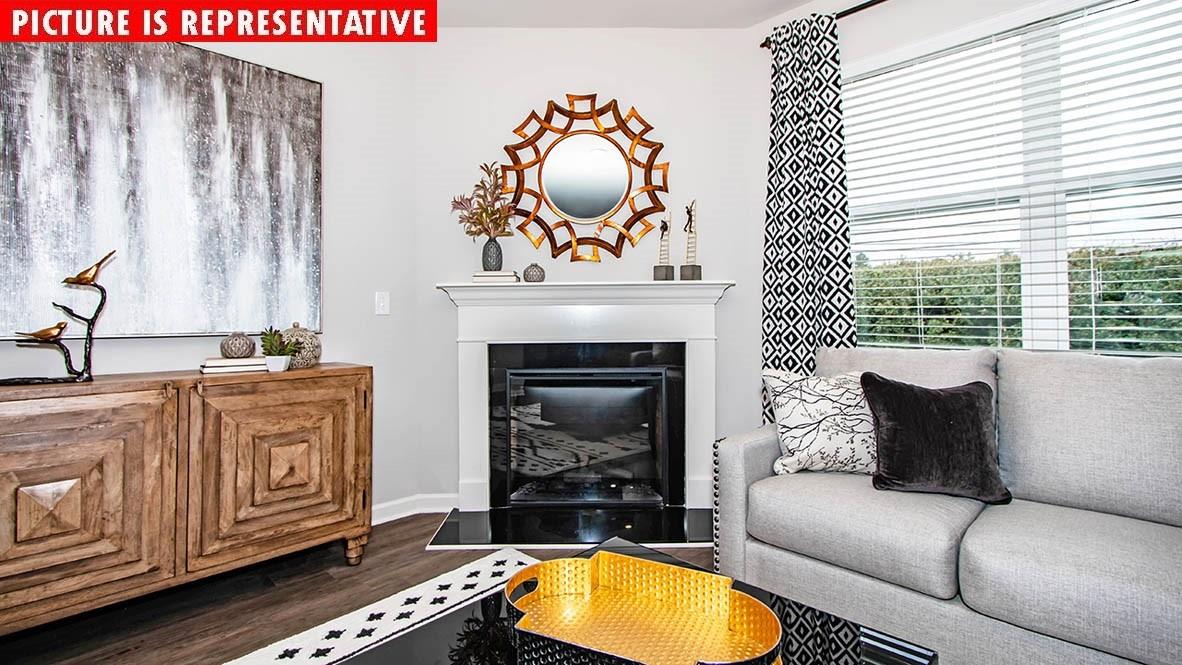 1204 Secrest Cmns Drive Monroe, NC 28112 - Photo 11 of 22 a living room with furniture a fireplace and a window