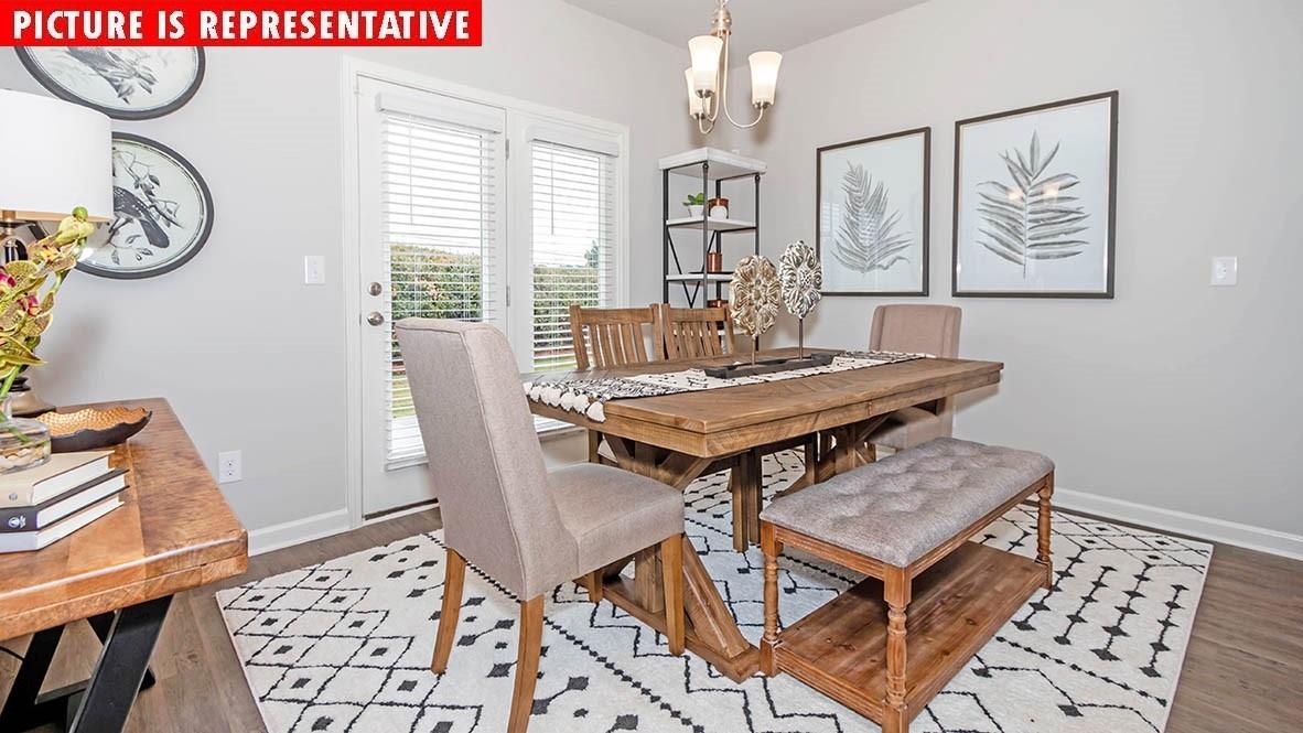 1204 Secrest Cmns Drive Monroe, NC 28112 - Photo 13 of 22 a view of a dining room with furniture window and wooden floor