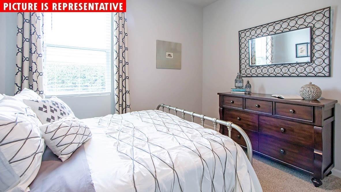 1204 Secrest Cmns Drive Monroe, NC 28112 - Photo 15 of 22 a bedroom with a bed and a window