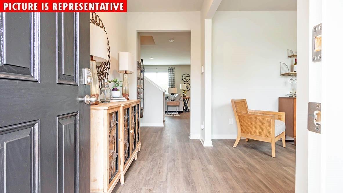 1204 Secrest Cmns Drive Monroe, NC 28112 - Photo 2 of 22 a living room with furniture and a wooden floor