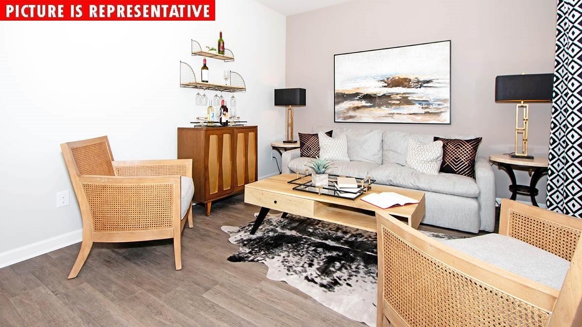 1204 Secrest Cmns Drive Monroe, NC 28112 - Photo 6 of 22 a living room with furniture and wooden floor