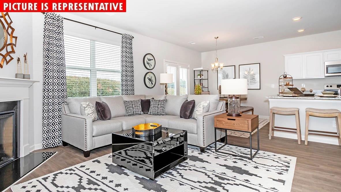 1204 Secrest Cmns Drive Monroe, NC 28112 - Photo 9 of 22 a living room with furniture and a fireplace