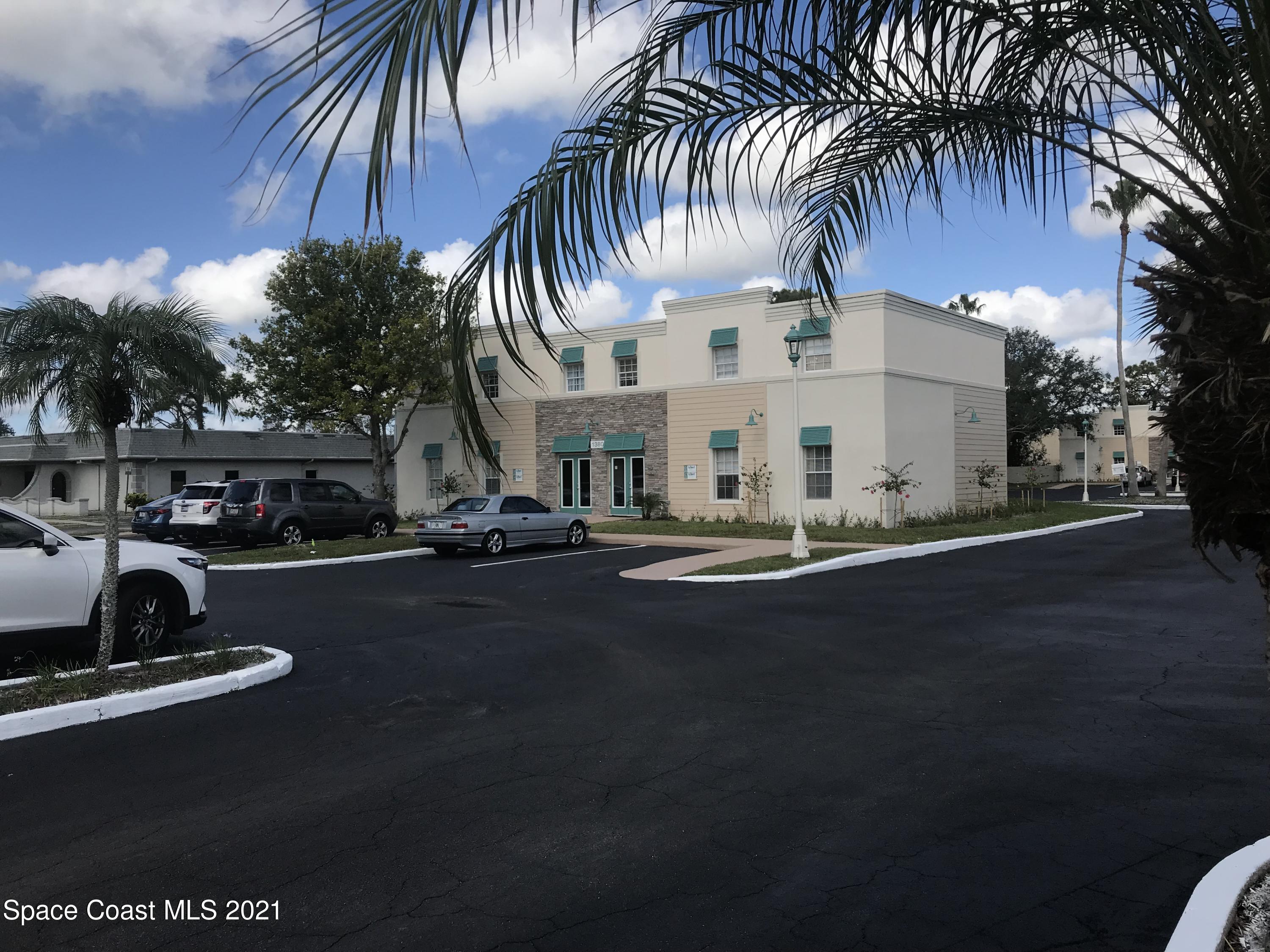 a view of multiple houses with palm trees