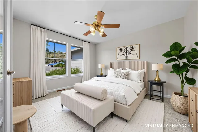 an empty room with window and ceiling fan