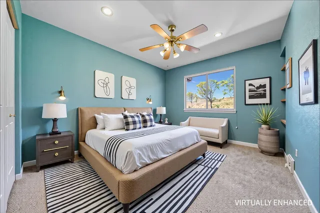 an empty room with window and ceiling fan