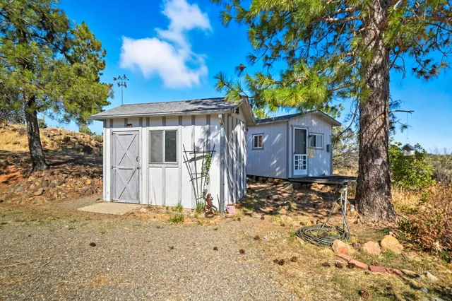 an aerial view of a house with a yard lake and ocean view