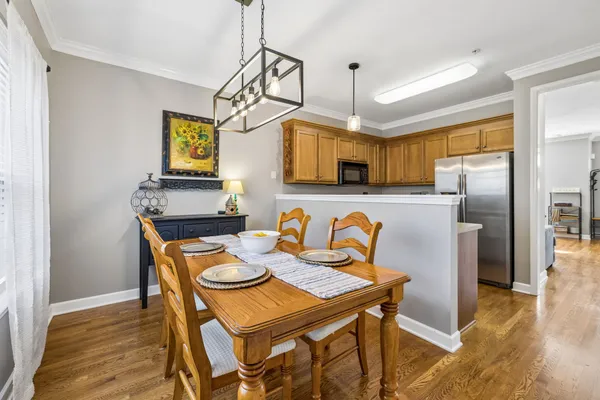 a view of a dining room with furniture and wooden floor