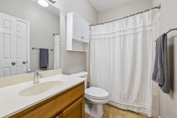 a bathroom with a sink a toilet and a mirror