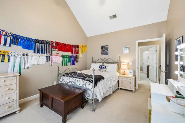 a bedroom with a bed next to a window and a walk in closet