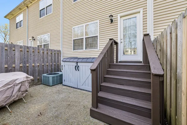 a view of a house with backyard and wooden fence