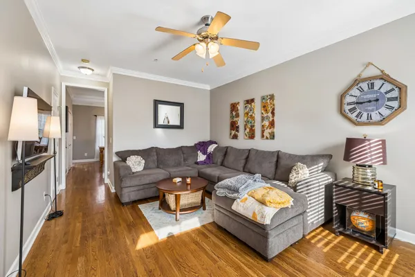 a living room with furniture and a wooden floor