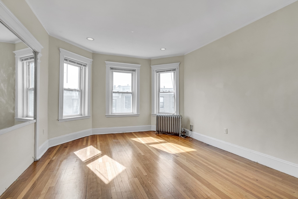 41 Orkney Road Boston, MA 02135 - Photo 12 of 28 an empty room with wooden floor and windows