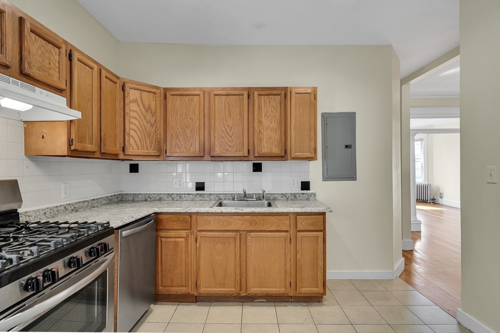 41 Orkney Road Boston, MA 02135 - Photo 14 of 28 a kitchen with a stove top oven sink and cabinets
